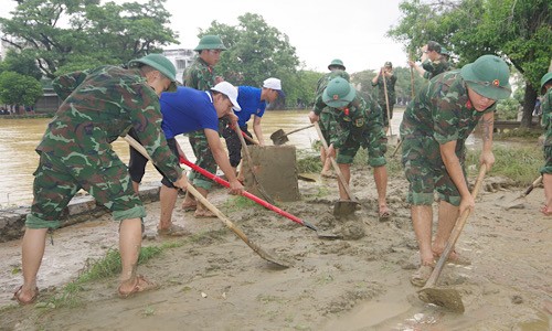 Cán bộ, chiến sĩ Bộ CHQS tỉnh Thừa Thiên Huế và lực lượng thanh niên địa phương tham gia dọn bùn, đất trên các tuyến đường.