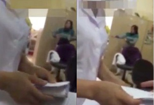 Nữ bác sĩ bệnh viện K nhận xấp phong bì từ người nhà bệnh nhân. Ảnh cắt từ clip