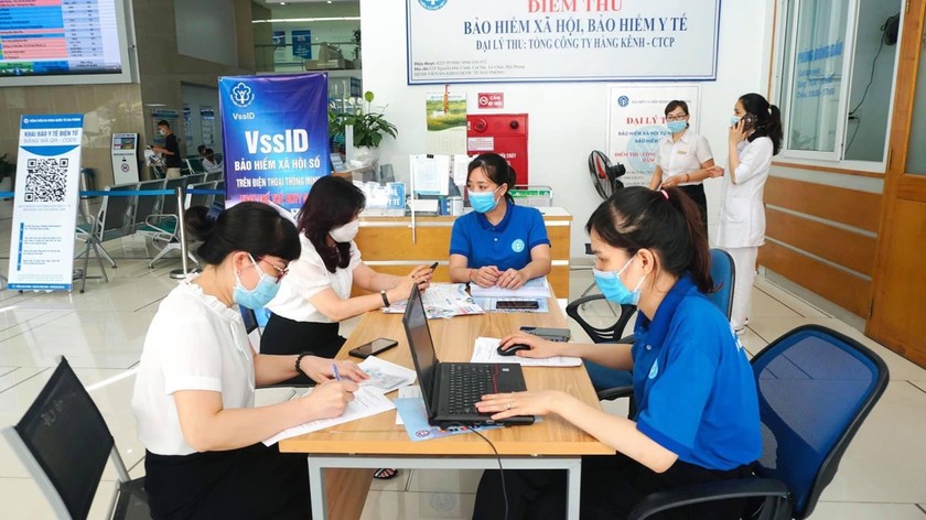 Cán bộ BHXH Hải Phòng hướng dẫn người dân thực hiện giao dịch điện tử. 