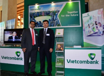 Ông Phạm Thanh Hà - Phó Tổng giám đốc Vietcombank tiếp đón các đại biểu, đối tác tham quan gian trưng bày triển lãm của Vietcombank trong khuôn khổ diễn đàn