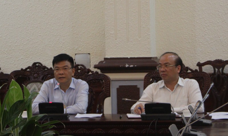 Bộ trưởng Lê Thành Long (trái) nghe báo cáo về quản lý tiền ảo