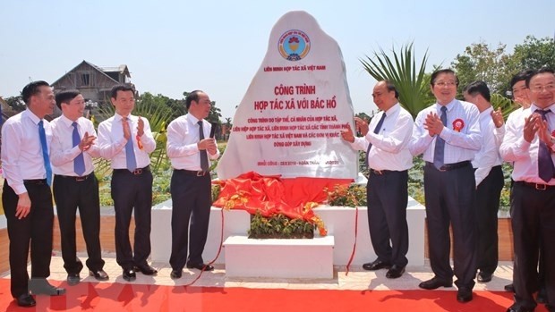 Thủ tướng Chính Phủ Nguyễn Xuân Phúc cùng các lãnh đạo gắn biển Công trình 'Hợp tác xã với Bác Hồ.' (Ảnh: Danh Lam/TTXVN)