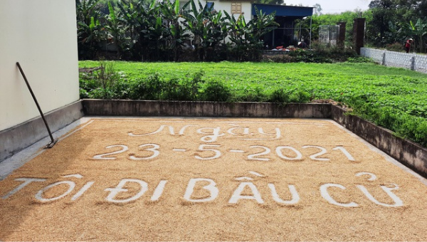 Khẩu hiệu "Ngày 23/5/2021 tôi đi bầu cử" được anh Hoàng Văn Ngọc thể hiện trên sân phơi lúa.