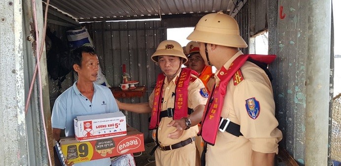 Thiếu tướng Trần Quốc Trung, Phó Cục trưởng Cục CSGT tặng quà người dân làng chài trên sông Cổ Cò, Đà Nẵng.