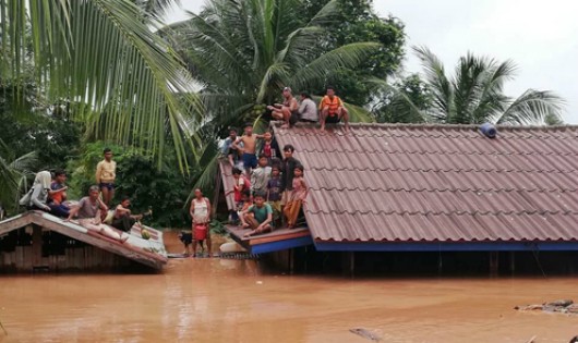 Người dân địa phương đã phải lên nóc nhà để tạm trú. Ảnh: Báo Tin tức/ABC Laos news.