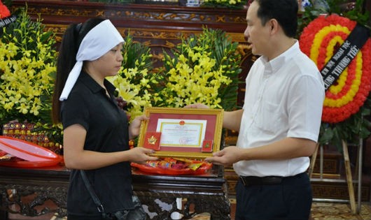 Ông Nguyễn Hoàng Phúc - Phó Giám đốc TT ĐPGTQG trao Kỷ niệm chương Vì sức khỏe nhân dân cho đại diện gia đình anh Hải