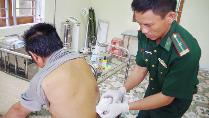Y sĩ, Thiếu tá Phương đang điều trị cho bệnh nhân tại Trạm quân dân y kết hợp tại Đồn Biên phòng Tam Hợp.