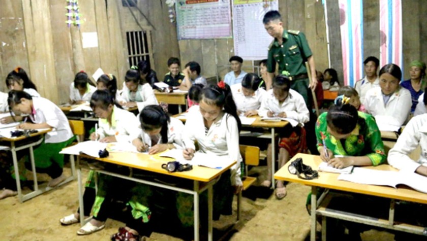 Trung úy Vàng Lao Lừ hướng dẫn học viên tại lớp học xóa mù bản Co Muông. Ảnh: Thanh Thuận
