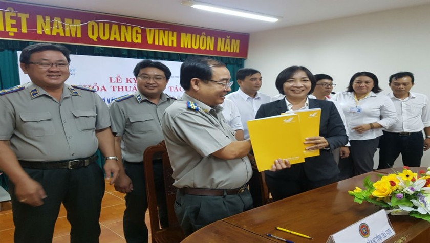 Cục Thi hành án dân sự tỉnh Trà Vinh ký kết thỏa thuận hợp tác với Bưu điện tỉnh Trà Vinh. (Ảnh: Thanh Nhàn)