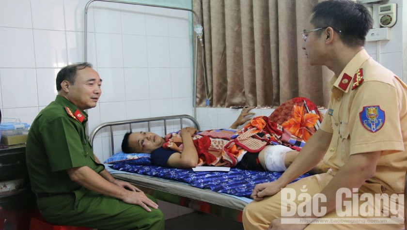 Đại tá Nguyễn Đình Hoàn, Phó Giám đốc Công an tỉnh Bắc Giang hỏi thăm sức khỏe cán bộ bị thương. Ảnh Báo Bắc Giang.