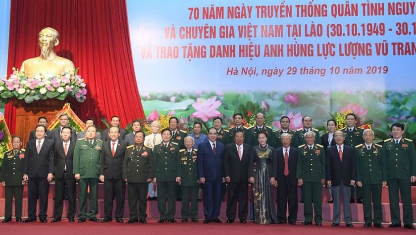 Tổng Bí thư, Chủ tịch nước CHDCND Lào Bounnhang Vourachith và Chủ tịch Quốc hội Nguyễn Thị Kim Ngân chụp ảnh chung với các đại biểu và đại diện quân tình nguyện và chuyên gia Việt Nam tại Lào.