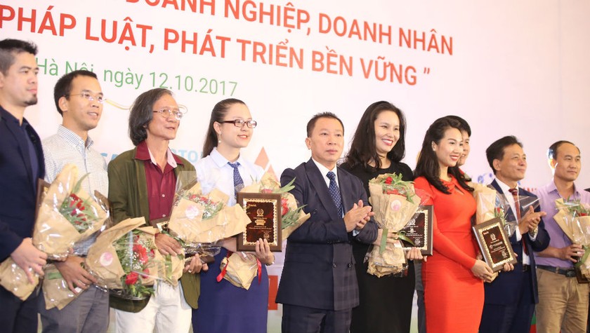 Tiến sĩ Đào Văn Hội, Tổng Biên tập Báo PLVN (thứ 5 từ trái qua), trao giải cho những tác giả đoạt giải tại Lễ trao giải chương trình năm 2017.