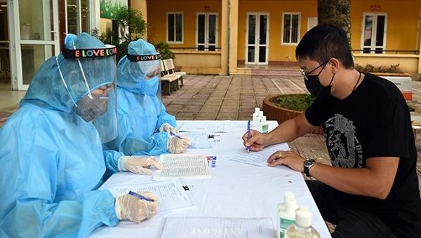 Người dân khai báo y tế tại điểm lấy mẫu xét nghiệm PCR ở quận Ba Đình, Hà Nội.