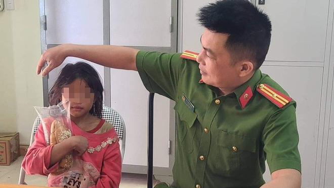 Bé gái bị lạc đường được công an xã Háng Đồng đưa về trụ sở chăm sóc.