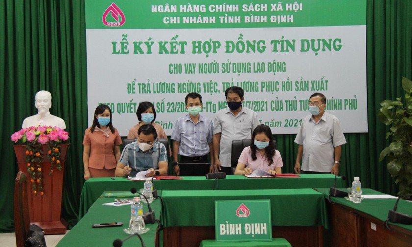 Đại diện Chi nhánh NHCSXH tỉnh Bình Định ký hợp đồng tín dụng với doanh nghiệp.