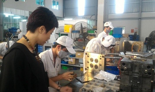 Chủ tịch Công ty Phan Thị Minh kiểm tra dây chuyền sản xuất linh kiện cơ khí xuất khẩu.