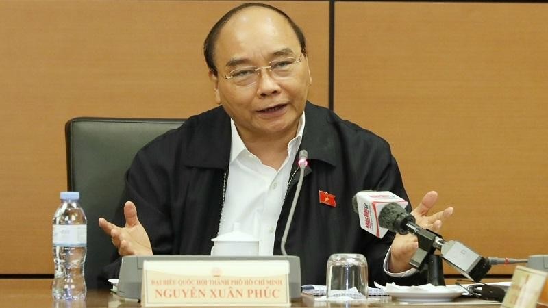 Chủ tịch nước Nguyễn Xuân Phúc thảo luận tại Tổ đại biểu Quốc hội. Ảnh: VGP