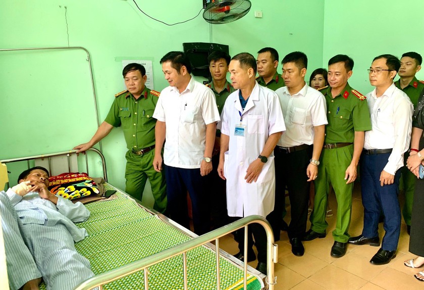 Ông Nguyễn Thanh Hoài, Chủ tịch UBND huyện Quỳ Châu, thăm, động viên Thiếu tá Tân đang điều trị (Ảnh: Kế Kiên).