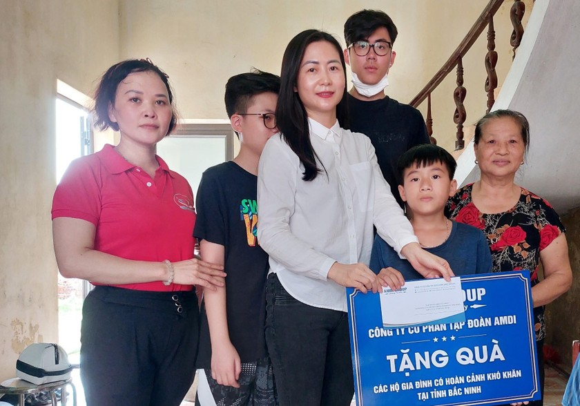 Đại diện AMDI GROUP, bà Dương Thị Bích Hạnh, Thành viên HĐQT Tập đoàn tặng quà các hộ gia đình có hoàn cảnh khó khăn 
