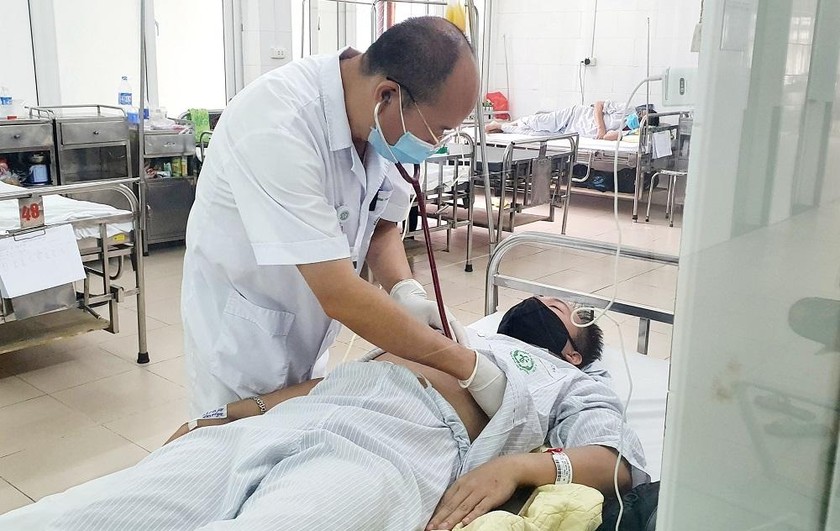 PGS.TS Đỗ Duy Cường, Giám đốc Trung tâm Bệnh nhiệt đới (Bệnh viện Bạch Mai) thăm khám cho bệnh nhân. Ảnh: Mai Thanh