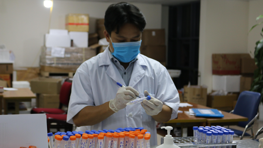 Cán bộ CDC Hà Nội nhận mẫu xét nghiệm sàng lọc SARS-CoV-2. Ảnh: Ngọc Nga