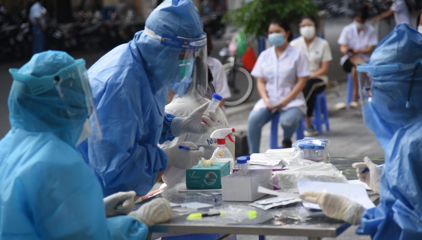 Các bác sĩ tiến hành lấy mẫu xét nghiệm những tường hợp liên quan đến ca bệnh tại Bệnh viện Hữu Nghị Việt Đức. Ảnh: Hoàng Lê