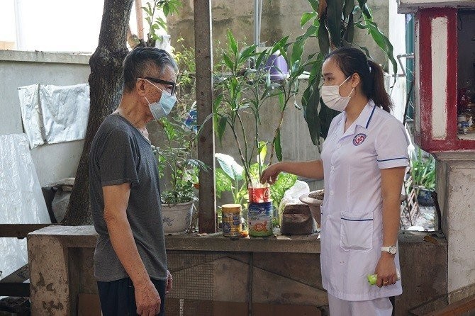 Cán bộ y tế hướng dẫn người dân vệ sinh môi trường tại hộ gia đình để phòng, chống sốt xuất huyết. Ảnh: Sở Y tế Hà Nội