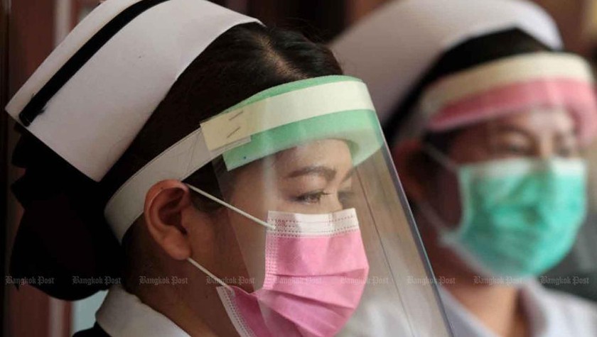 Nhân viên y tế với tấm che mặt tạm thời tại Bệnh viện Siriraj ở Bangkok. Ảnh: BKP