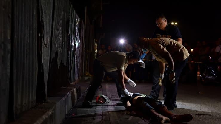 Cảnh sát điều tra khám nghiệm thi thể của một nạn nhân không rõ danh tính vào ngày 10/11/2016 tại thành phố Pasay, Philippines. Ảnh: Getty Images