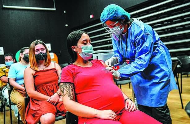 Một phụ nữ mang thai được tiêm vaccine COVID-19 tại một trung tâm ở Medellin, Colombia, vào ngày 24/7/2021. Ảnh: AFP