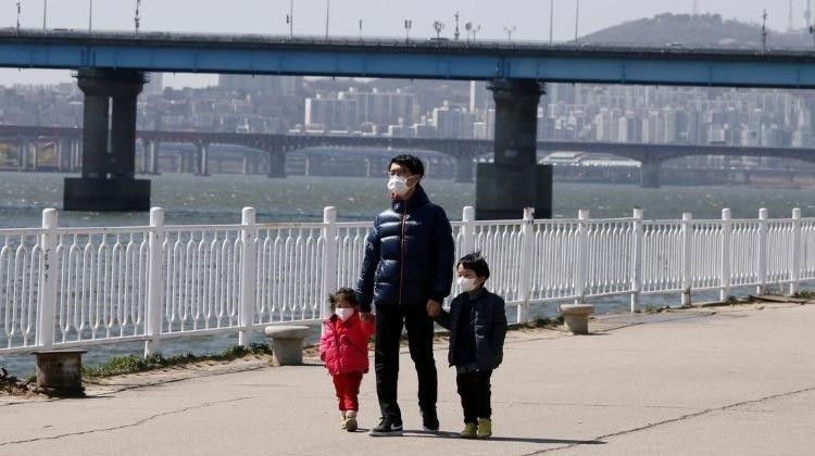Ba cha con đeo khẩu trang đi dạo tại Công viên sông Hàn ở Seoul, Hàn Quốc. Ảnh: REUTERS