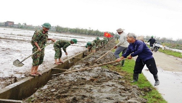 Cán bộ, chiến sĩ giúp nhân dân vét bùn tại các kênh mương nội đồng