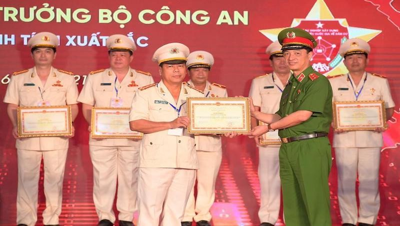 Đại tá Nguyễn Văn Thanh (bên trái) thay mặt Công an Quảng Trị nhận bằng khen của Bộ trưởng Bộ Công an.