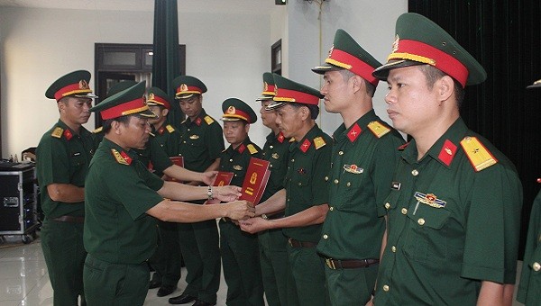 Thượng tá Hà Văn Ái, Phó Chính ủy Bộ chỉ huy quân sự tỉnh trao Quyết định thăng quân hàm cho các đồng chí Đại úy lên Thiếu tá.