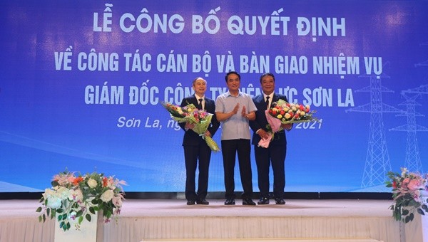 Lãnh đạo Tổng Công ty Điện lực Miền Bắc trao Quyết định và tặng hoa chúc mừng ông Trần Duy Trinh và ông Cầm Văn Giao.