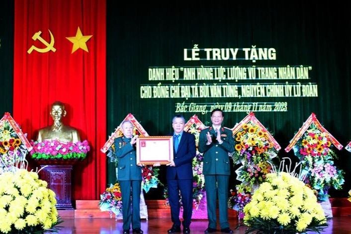 Thiếu tướng Trần Danh Khải trao danh hiệu Anh hùng LLVTND với cố Đại tá Bùi Văn Tùng cho đại diện gia đình.