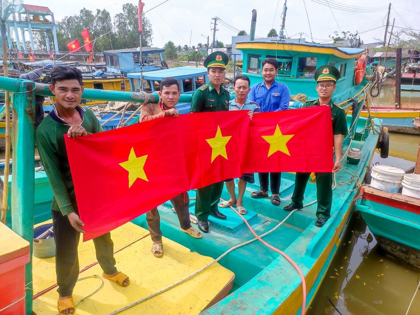Đồn Biên phòng Trung Bình - BĐBP Sóc Trăng phối hợp tặng cờ Tổ quốc, kết hợp tuyên truyền chống khai thác IUU cho ngư dân.