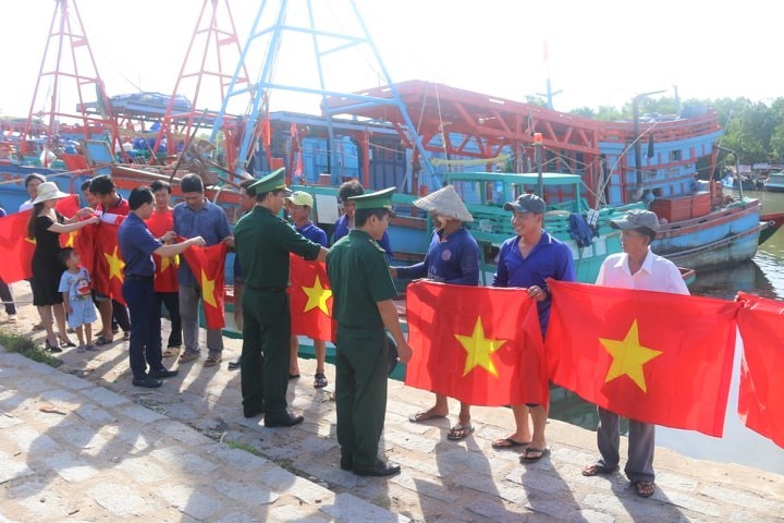 Đoàn công tác Báo PLVN phối hợp với BĐBP tỉnh Kiên Giang có mặt tại các đội tàu đánh bắt xa bờ để trao tận tay ngư dân những lá cờ Tổ quốc 