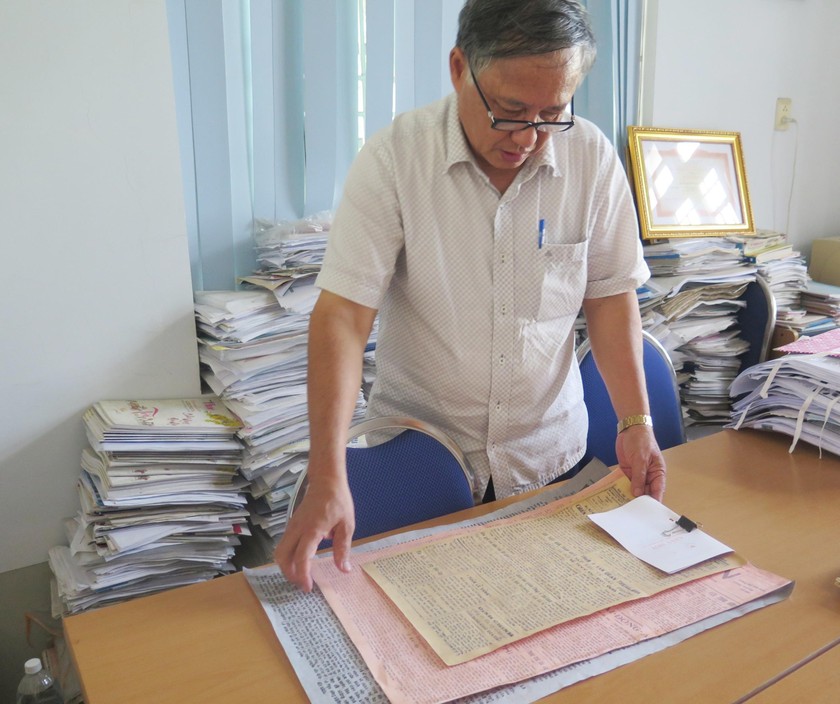 Nhà báo, nhà nghiên cứu Dương Phước Thu nâng niu những tờ báo cũ. 