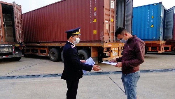 Lực lượng hải quan Quảng Trị phát khẩu trang và tờ rơi về việc phòng, chống bệnh đường hô hấp cấp do chủng mới của virus corona cho các tài xế ở khu vực cửa khẩu Lao Bảo (ảnh: HQQT)