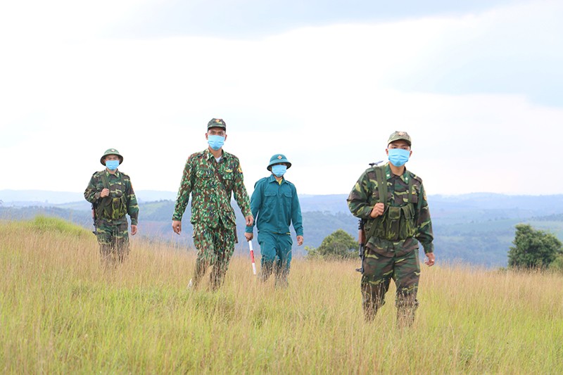Chiến sĩ Đồn Biên phòng Đắk Tiên và dân quân xã Thuận Hạnh tuần tra, bảo vệ biên giới phòng, chống xâm nhập của dịch bệnh Covid-19