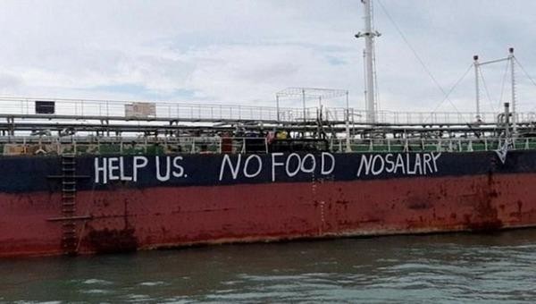 "Xin hãy giúp chúng tôi. Không thực phẩm. Không lương" - dòng chữ cầu cứu của các thủy thủ trên tàu Việt Tín 01 tại khu neo đậu Johor, Malaysia. (Ảnh: NUSPM).
